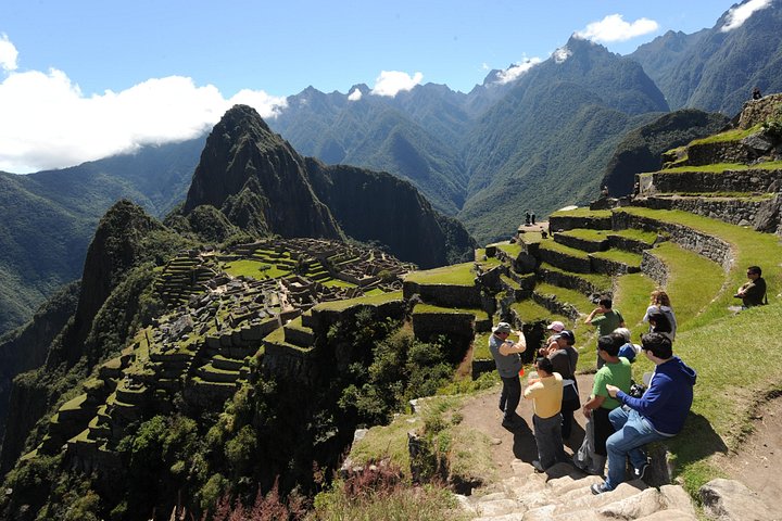 Visitors seated above the Machu Picchu ruins