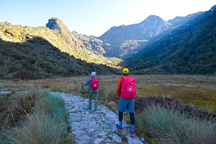 Hikers crossing a high Andean wetland