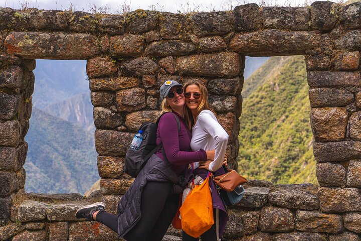 Two visitors framed in an Inca window