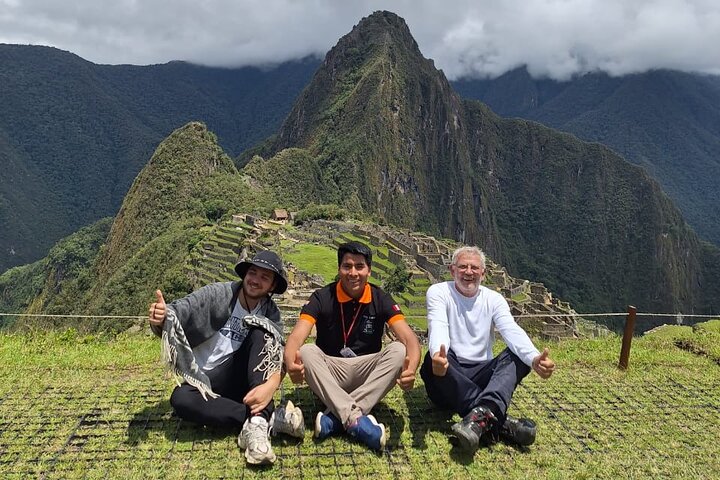 Visitors resting above the Machu Picchu ruins