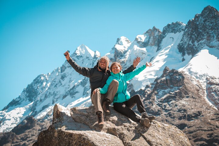 Two trekkers celebrating below Salkantay