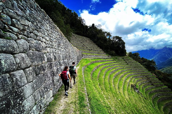 A hiker on Inca stonework above the valley